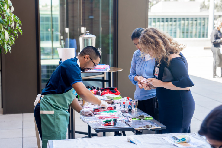 DoM staff member and artist Chris Cabunag leads participants through a collaborative mural painting exercise.